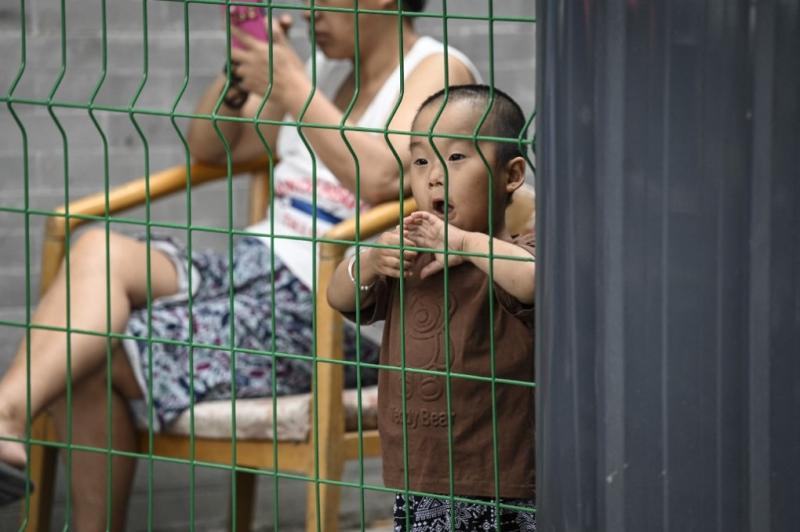 Một em bé sau hàng rào phong tỏa ở Bắc Kinh ngày 14/6. Ảnh: AFP